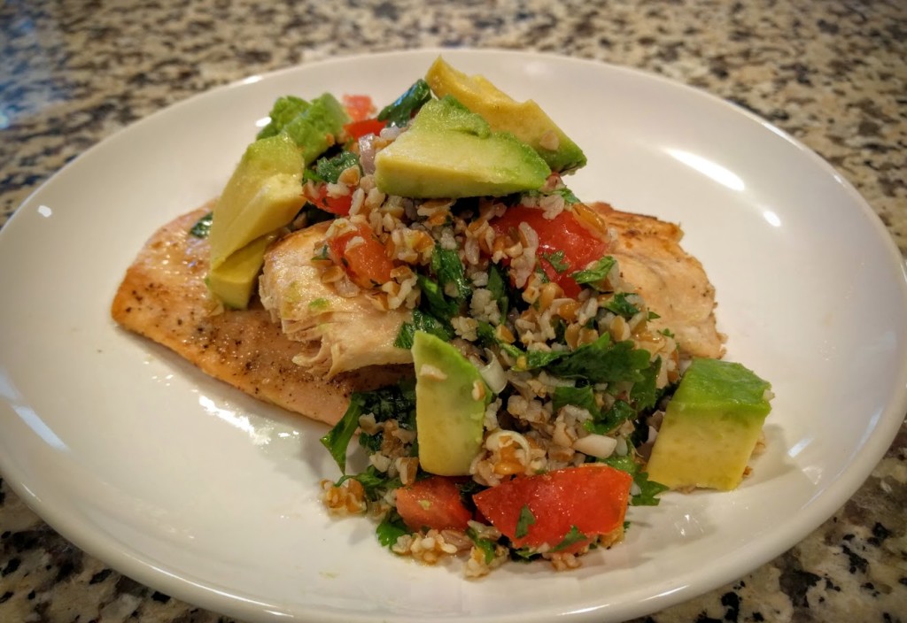 Salmon topped with tabouleh and avocado